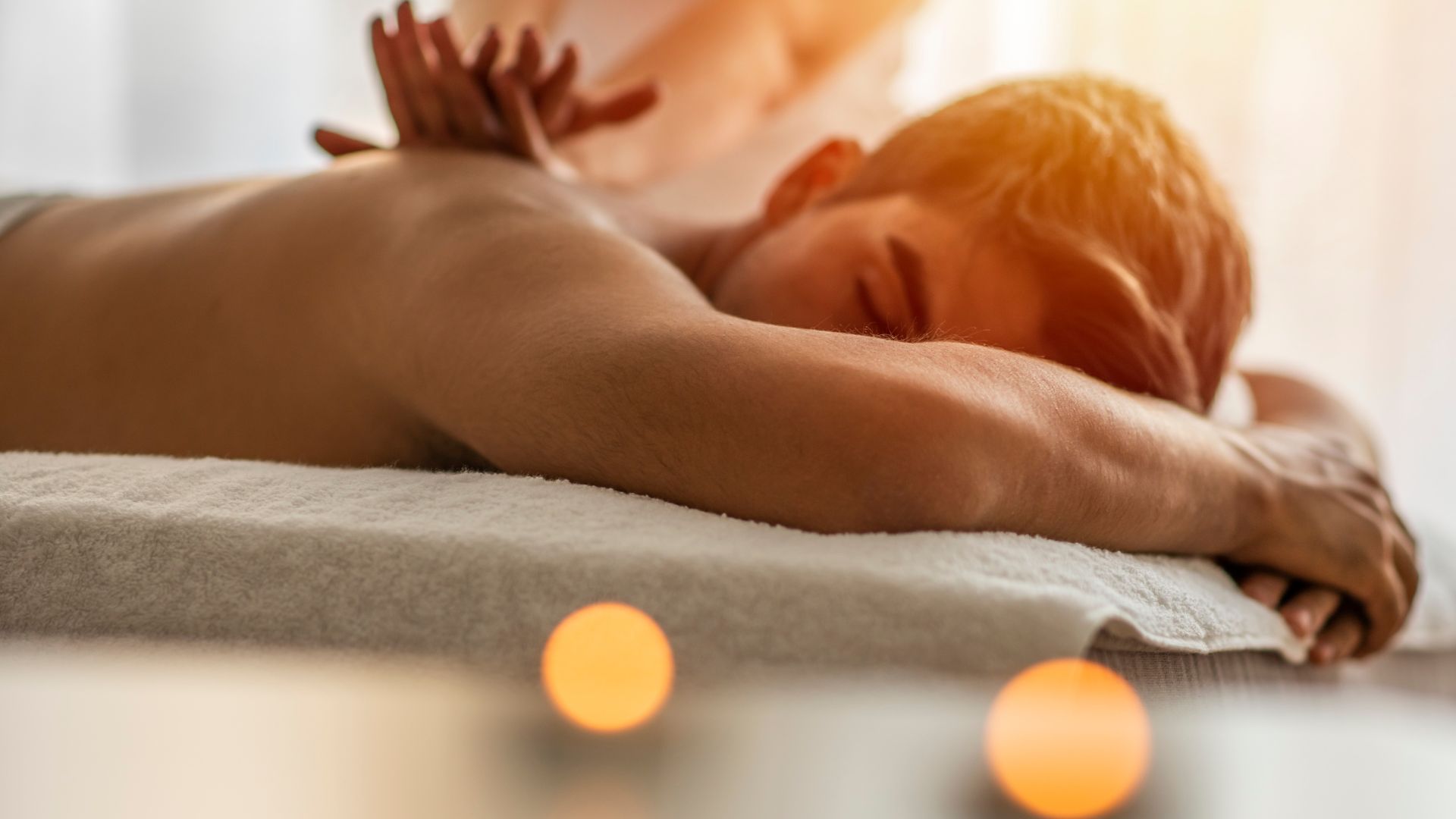 Artistic photo of a man receiving a relaxing massage at Agigma Holistic Spa