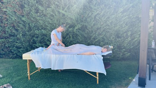Spa therapist applying glow mask at a villa pool in Crete